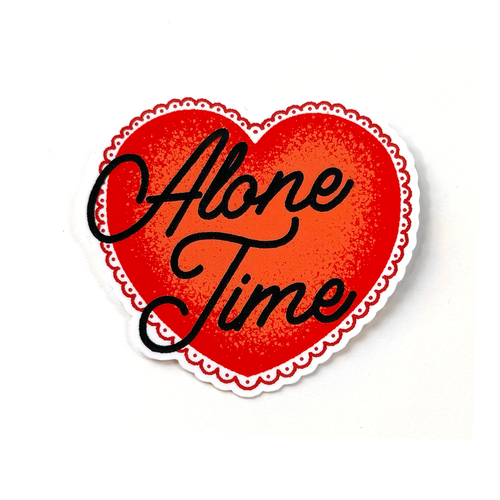 Red heart sticker with black hand-drawn script typography reading “Alone Time” in a clean, minimalist style.