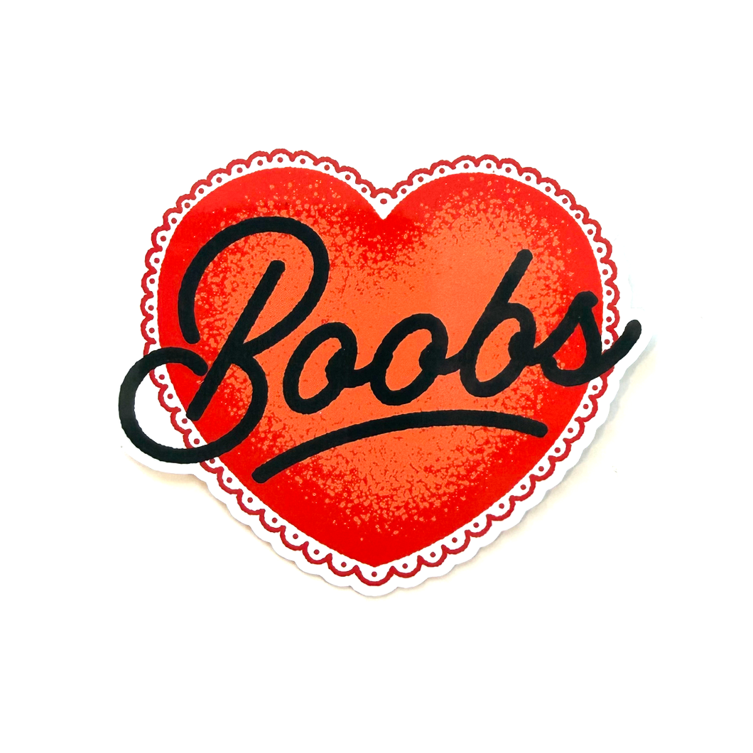 Red heart sticker with black hand-drawn script typography reading “boobs” in a clean, minimalist style.