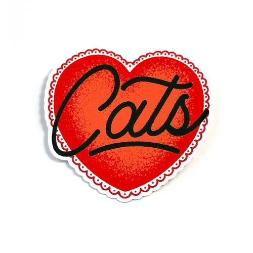 A heart-shaped sticker with a red textured center, black cursive text reading 'Cats', and a scalloped white border on a white background.