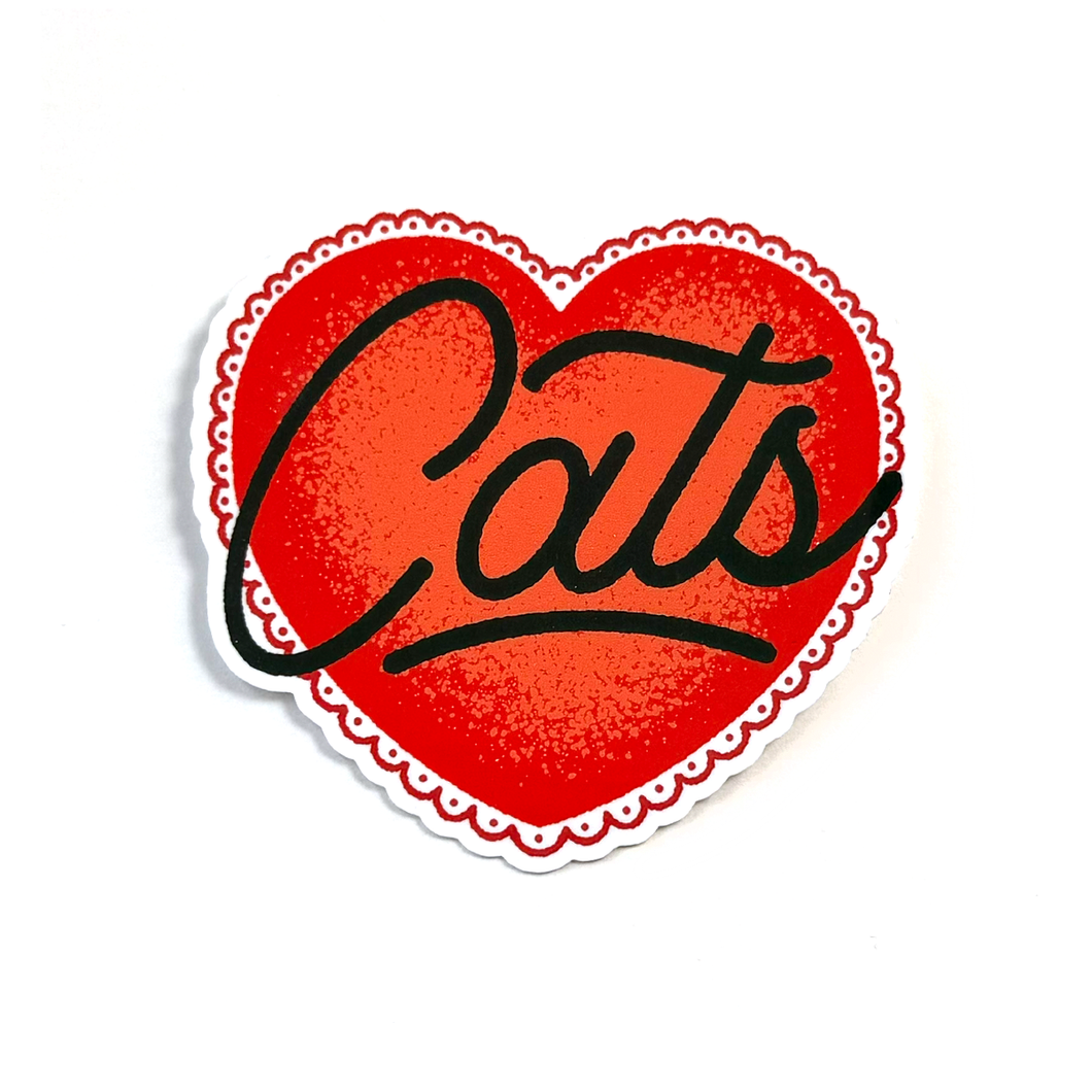 A heart-shaped sticker with a red textured center, black cursive text reading 'Cats', and a scalloped white border on a white background.