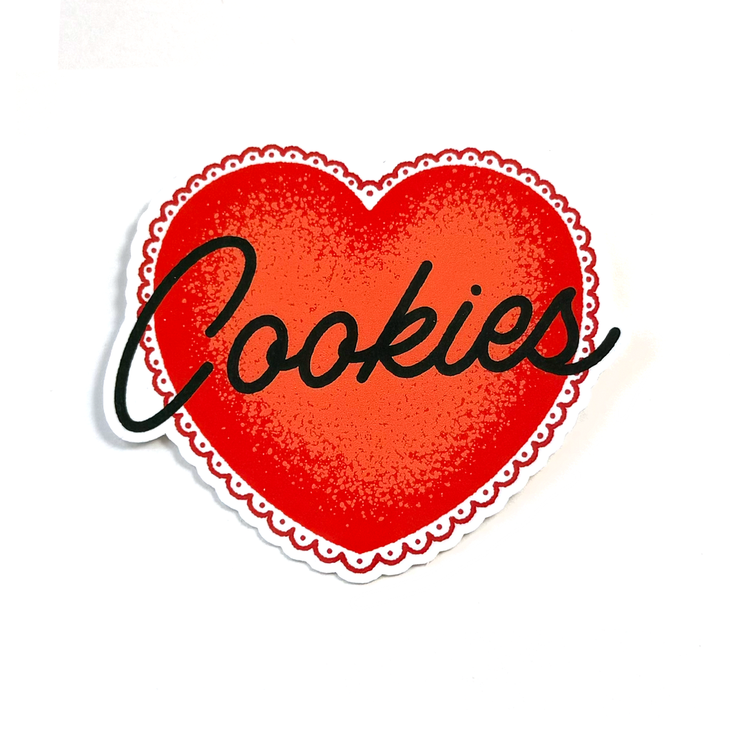 A heart-shaped sticker or decal with a red textured center, a scalloped white border, and the word 'Cookies' written across it in black script, shown on a plain white background.