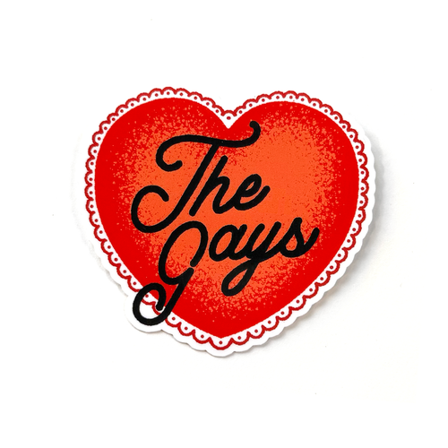 Red heart sticker with black hand-drawn script typography reading “The Gays” in a clean, minimalist pride-inspired style.