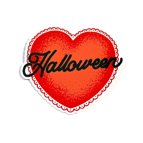 A die-cut sticker featuring a red heart with a scalloped white border and the word 'Halloween' written across it in black script, shown on a plain white background.