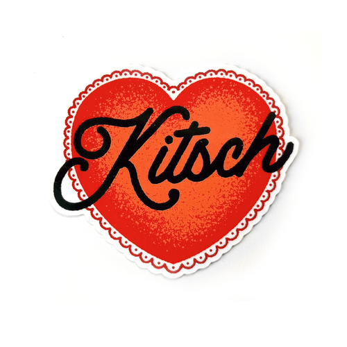 A red heart-shaped sticker with a white scalloped border and the word Kitsch written in black cursive text across the center.