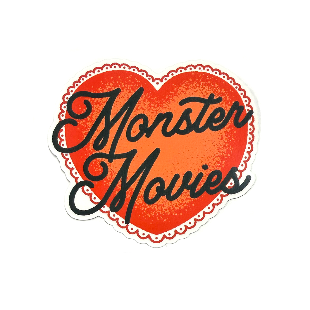Red heart sticker with black hand-drawn script typography reading “Monster Movies” in a clean, minimalist horror-inspired style.