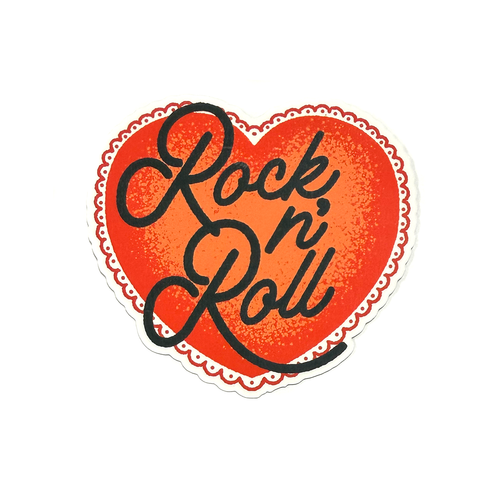 Red heart sticker with black hand-drawn script typography reading “Rock n' Roll” in a clean, minimalist style.
