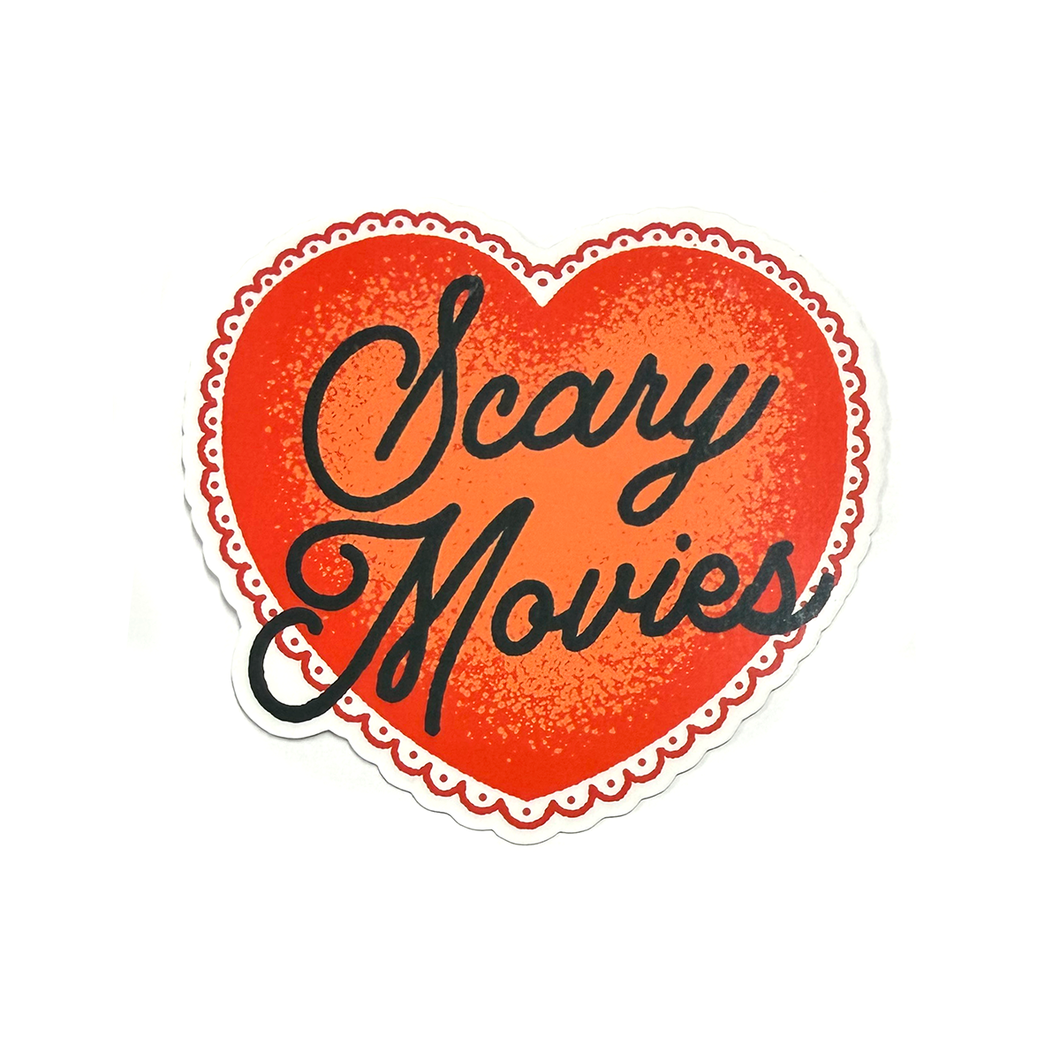 Red heart sticker with black hand-drawn script typography reading “Scary Movies” in a clean, minimalist horror-inspired style.