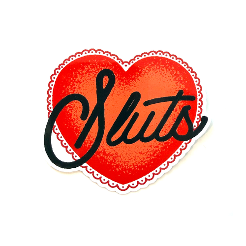 Red heart sticker with black hand-drawn script typography reading “Sluts” in a clean, minimalist style.