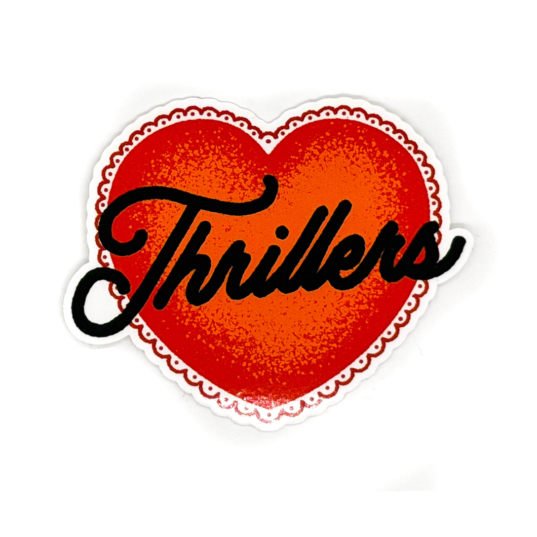 A die-cut sticker featuring a red heart with a textured glitter-like finish, a scalloped white border, and the word 'Thrillers' in black cursive script across the center, shown on a plain white background.